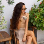 stylish-woman-summer-crop-top-straw-skirt-drinking-coffe-modern-cafe-enjoing-summer-vacations-europe_273443-5494